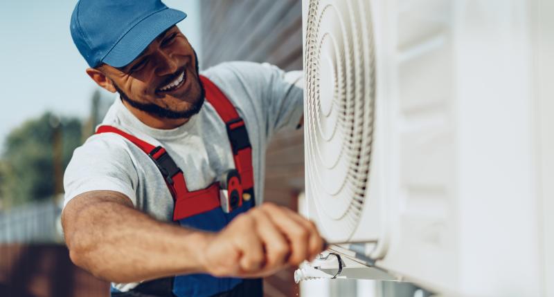 Man repairing air conditioning system in the summer